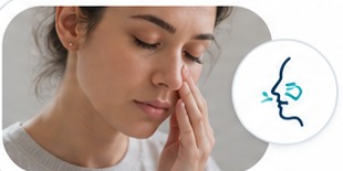 Woman pressing her fingers beside her nose
